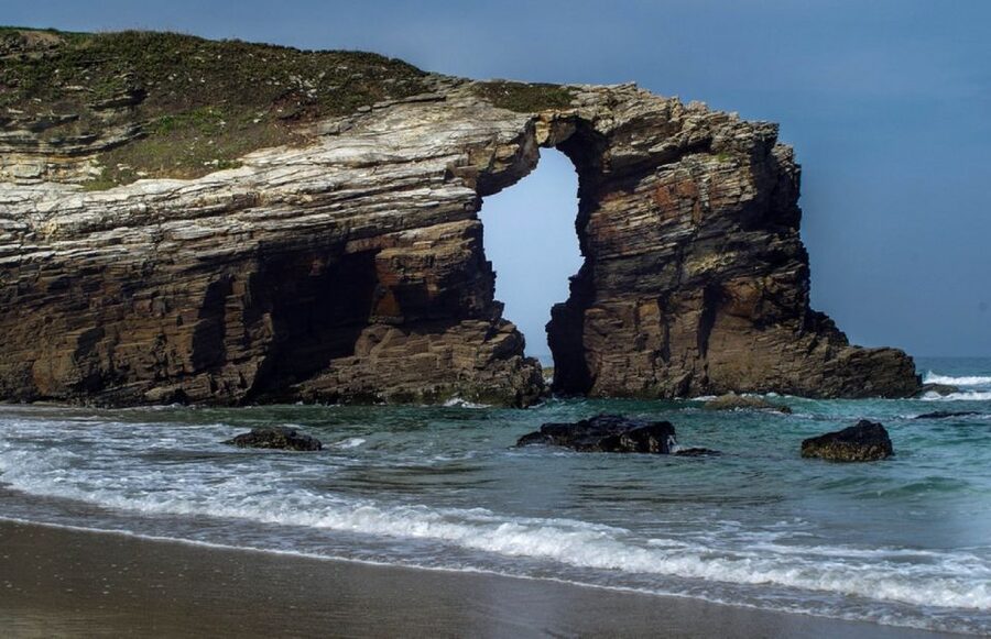 From A Coruna: Guided Day Trip to Lugo & As Catedrais Beach - Walking beneath As Catedrais Beach arches