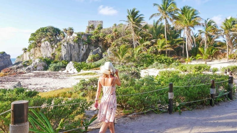 From Cancun: Day Trip to Tulum, Cenote & Playa del Carmen - Tulum ruins with a guide and a sea view