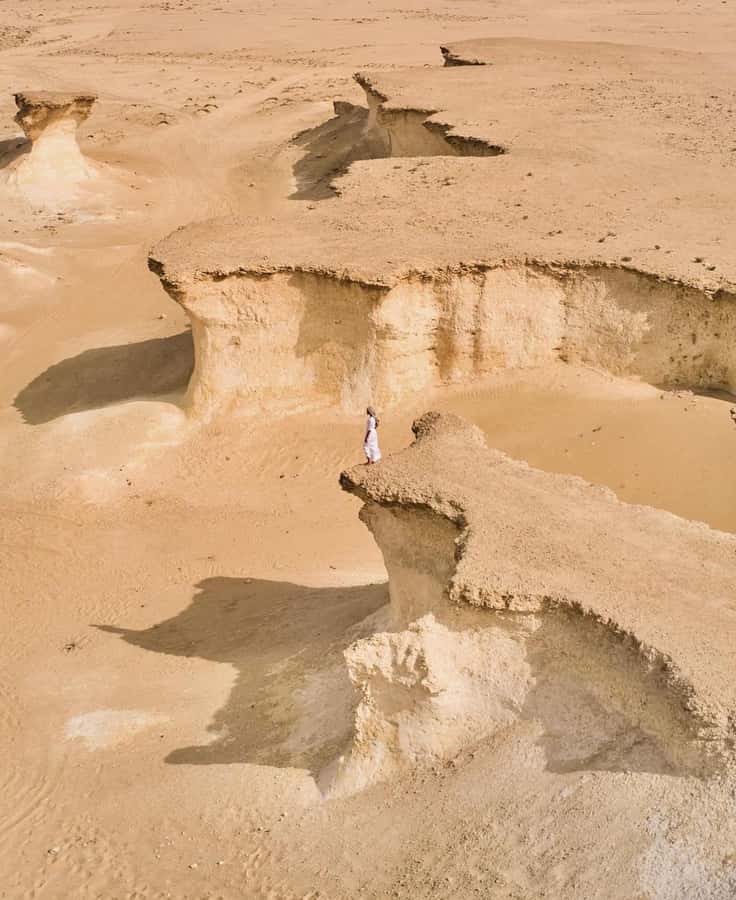 From Doha: Day Trip to North And West Qatar With Pickup - Jumail’s abandoned limestone homes