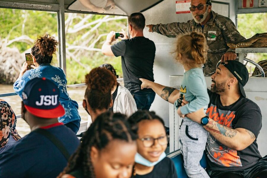 New Orleans: Oak Alley Plantation and Swamp Cruise Day Trip - A covered boat through the bayou